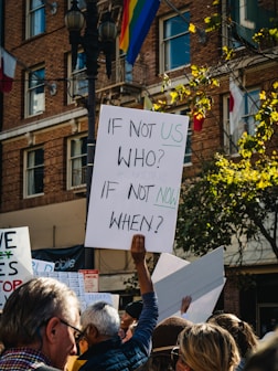 man holding if not us who poster