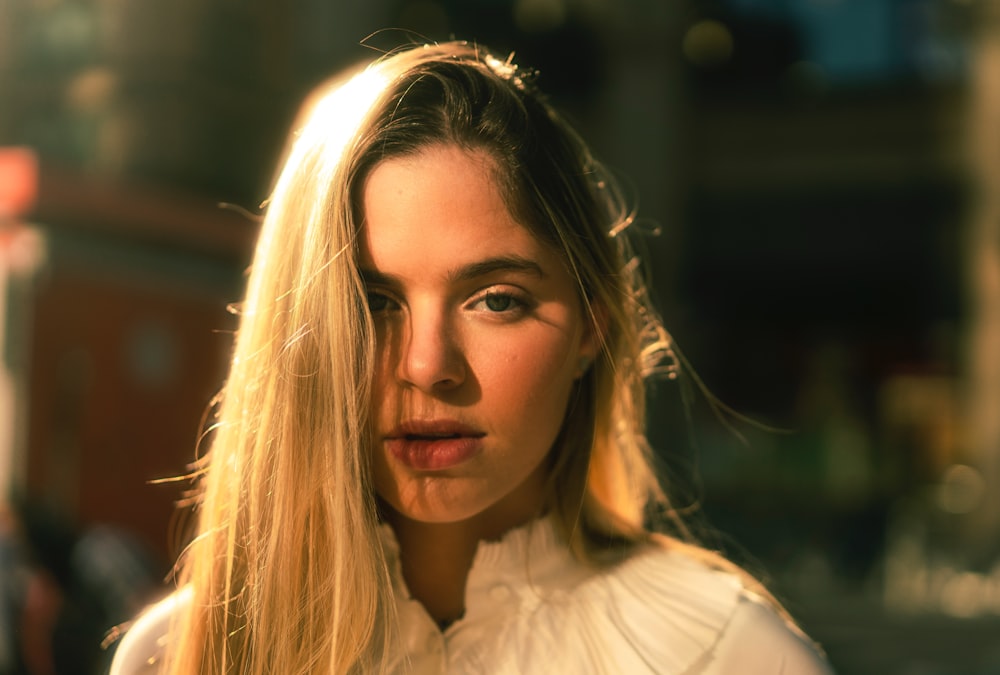 woman wearing white blouse looking straight