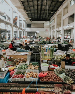 different goods displayed in market inside white building