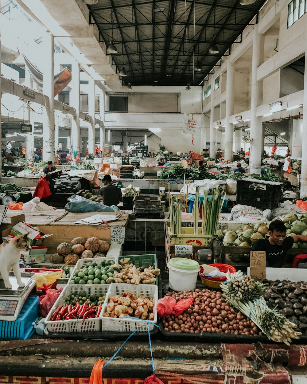 different goods displayed in market inside white building