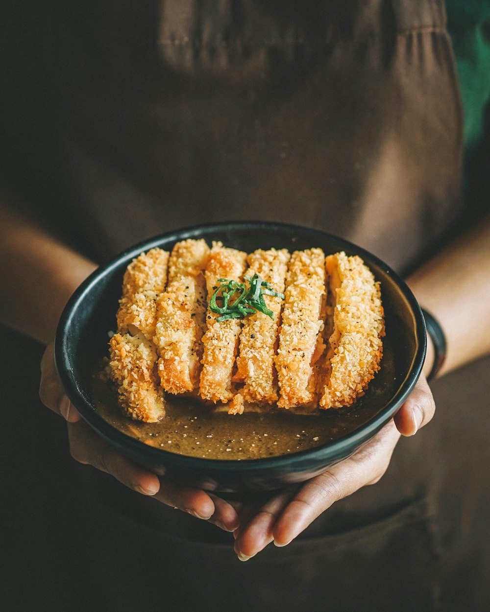 丸い黒い皿の上の揚げ物