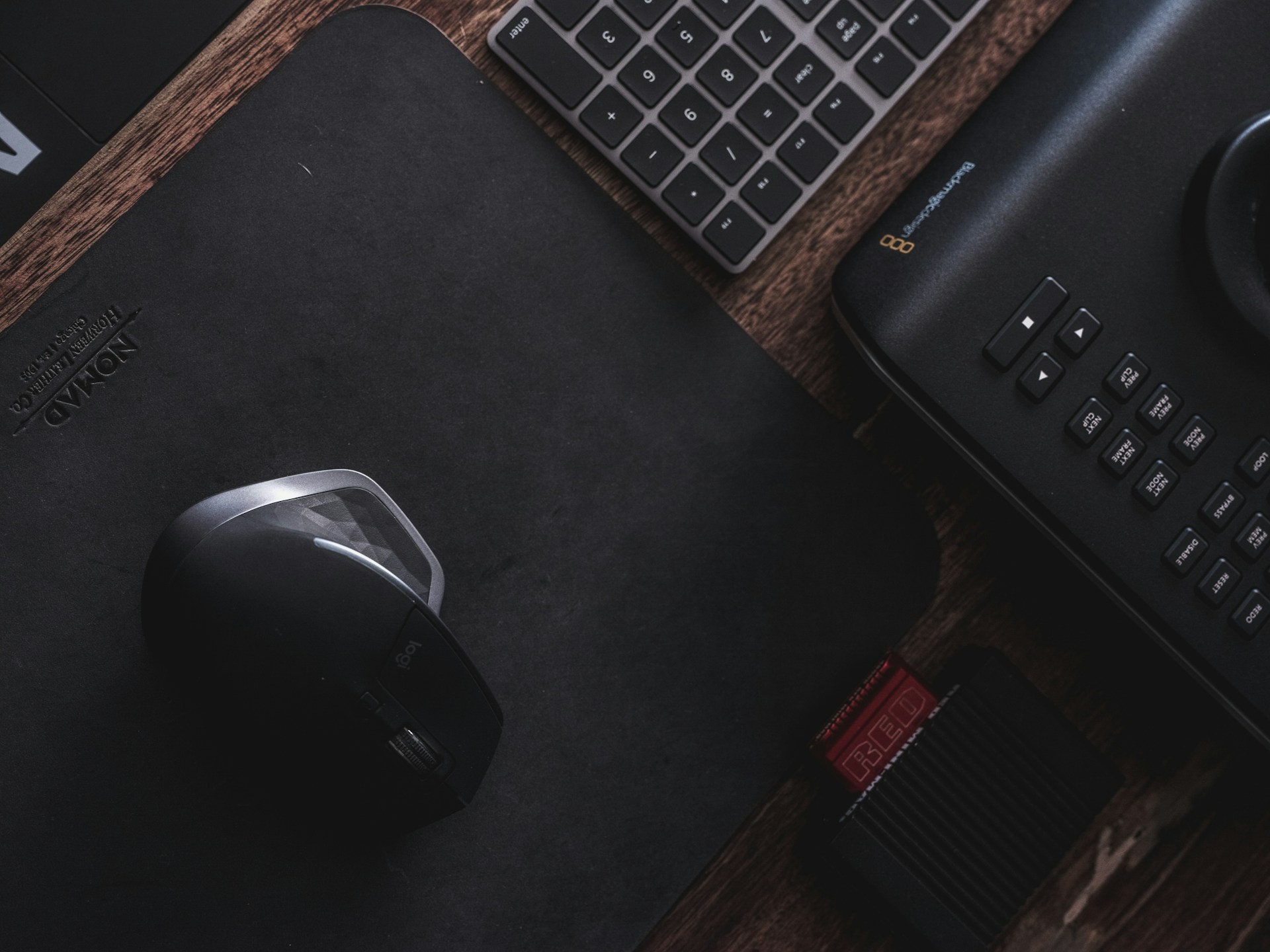 a mouse, keyboard, and mouse pad on a desk