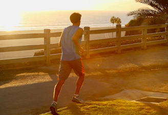 Dynamic runner sprinting along a coastal trail in Tenerife with ocean views.