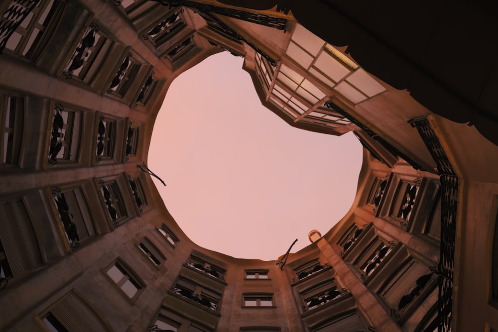 low angle photography of building under cloudy sky