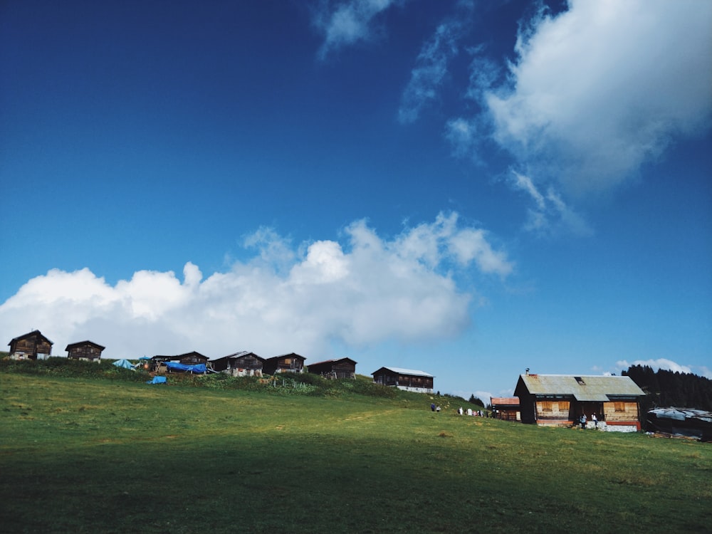 a group of houses on a hill under a blue sky