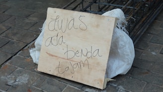 A close-up of a PVC sign with clear lettering.