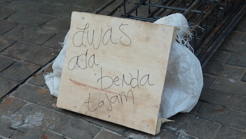 A close-up of a PVC sign with clear lettering.