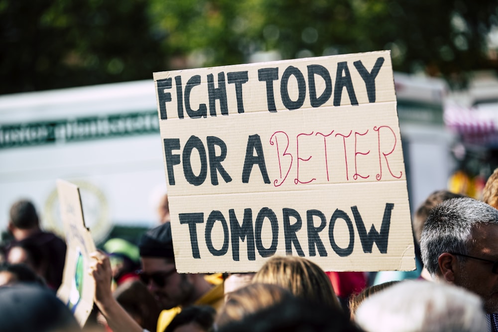 person holding fight today for a better tomorrow sign