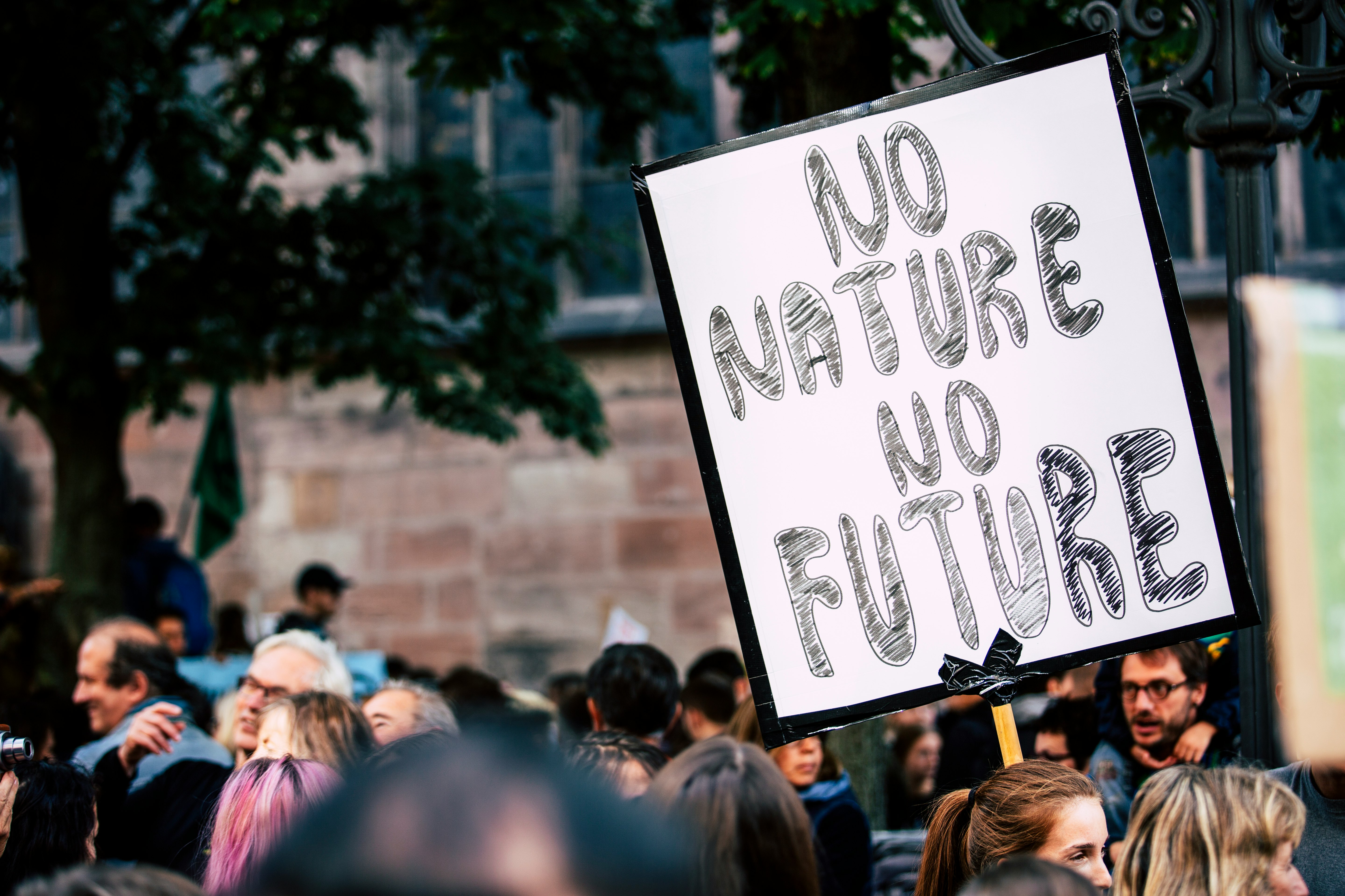 man holding No Mature No Future signage