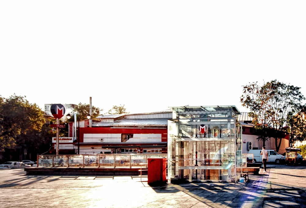 trees beside white and red building