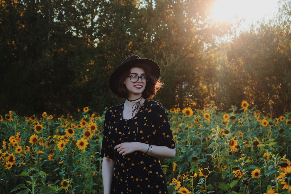 woman standing near sunflowers