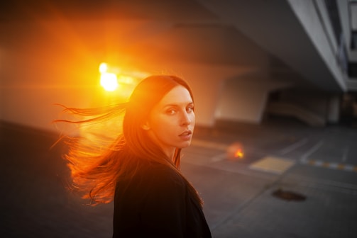 A vivid portrait shot capturing natural light with a soft urban background.