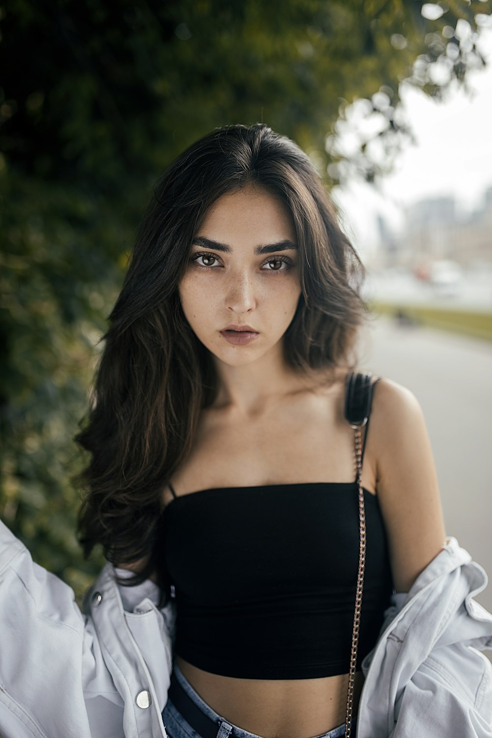 woman wearing black spaghetti strap square-neck crop top near tree