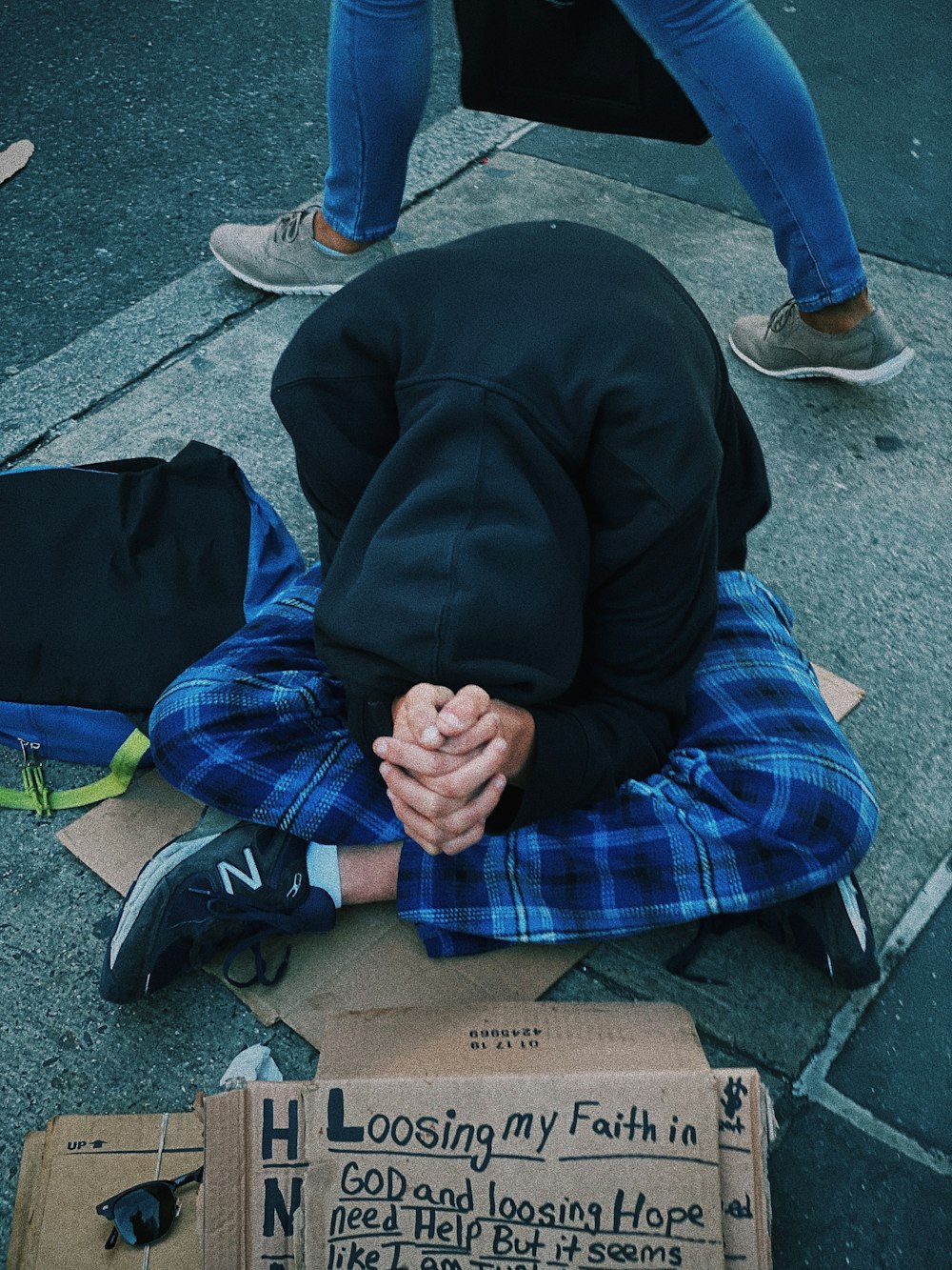 person sitting on cardboard