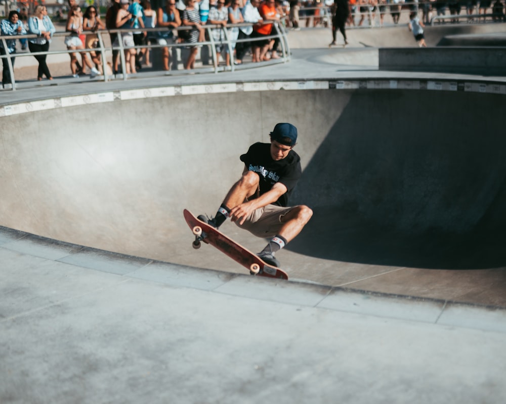 man riding on skateboard in skateboard track