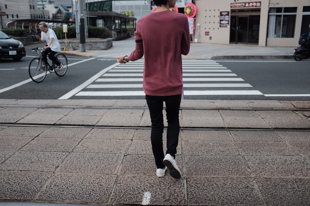 man walking in front of pedestrian lane