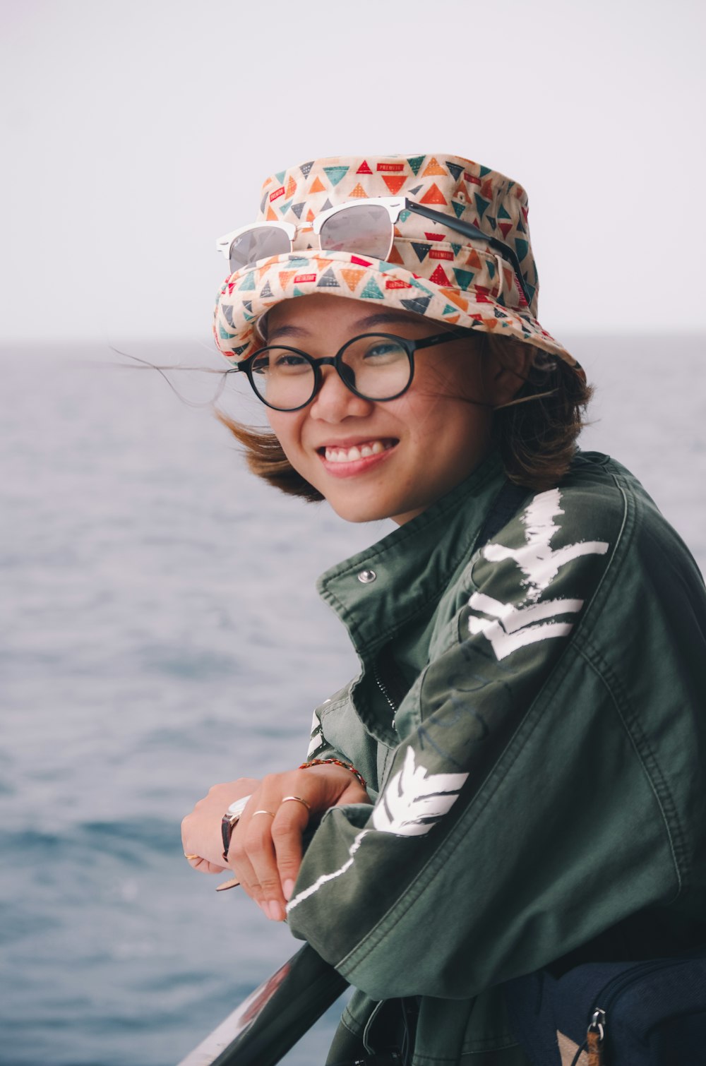 woman wearing green jacket and bucket hat