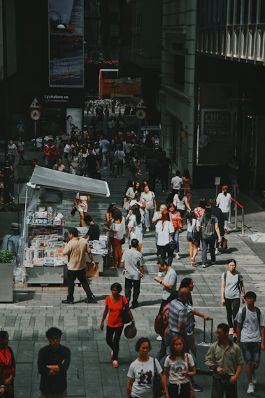 A vibrant street scene in an Urdu-speaking city with people reading newspapers and using smartphones.
