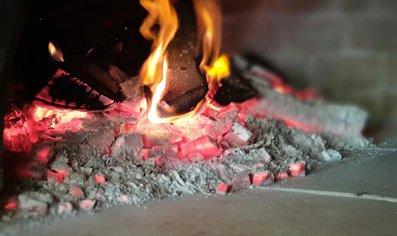 A cozy fireplace with glowing embers, symbolizing warmth and trust.