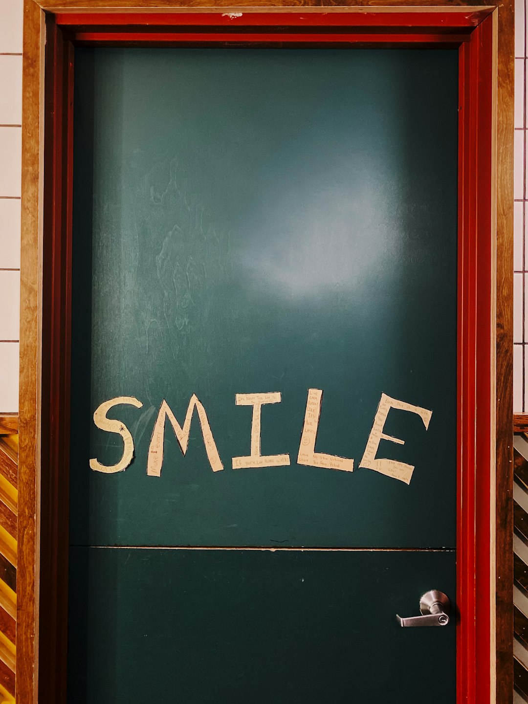 closed blue wooden smile printed door