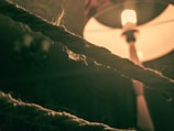 Close-up of a macramé light glowing warmly in a cozy room.