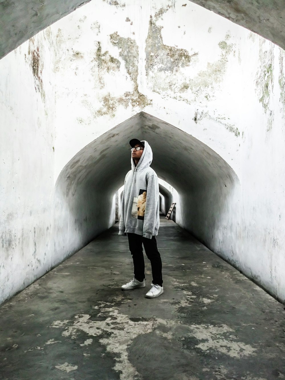 man standing on concrete tunnel