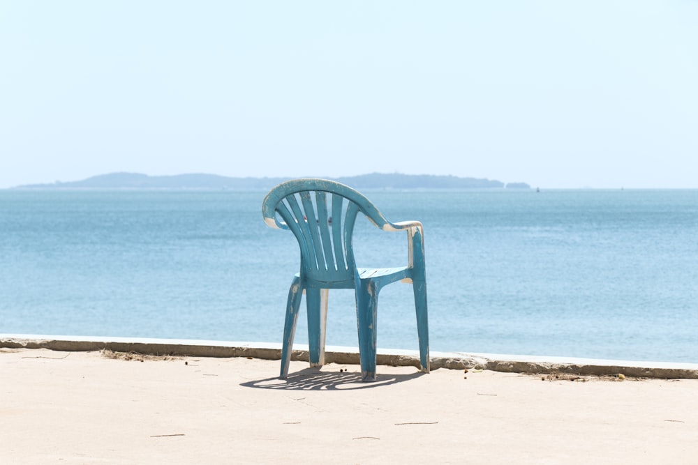 blue monobloc armchair front of sea