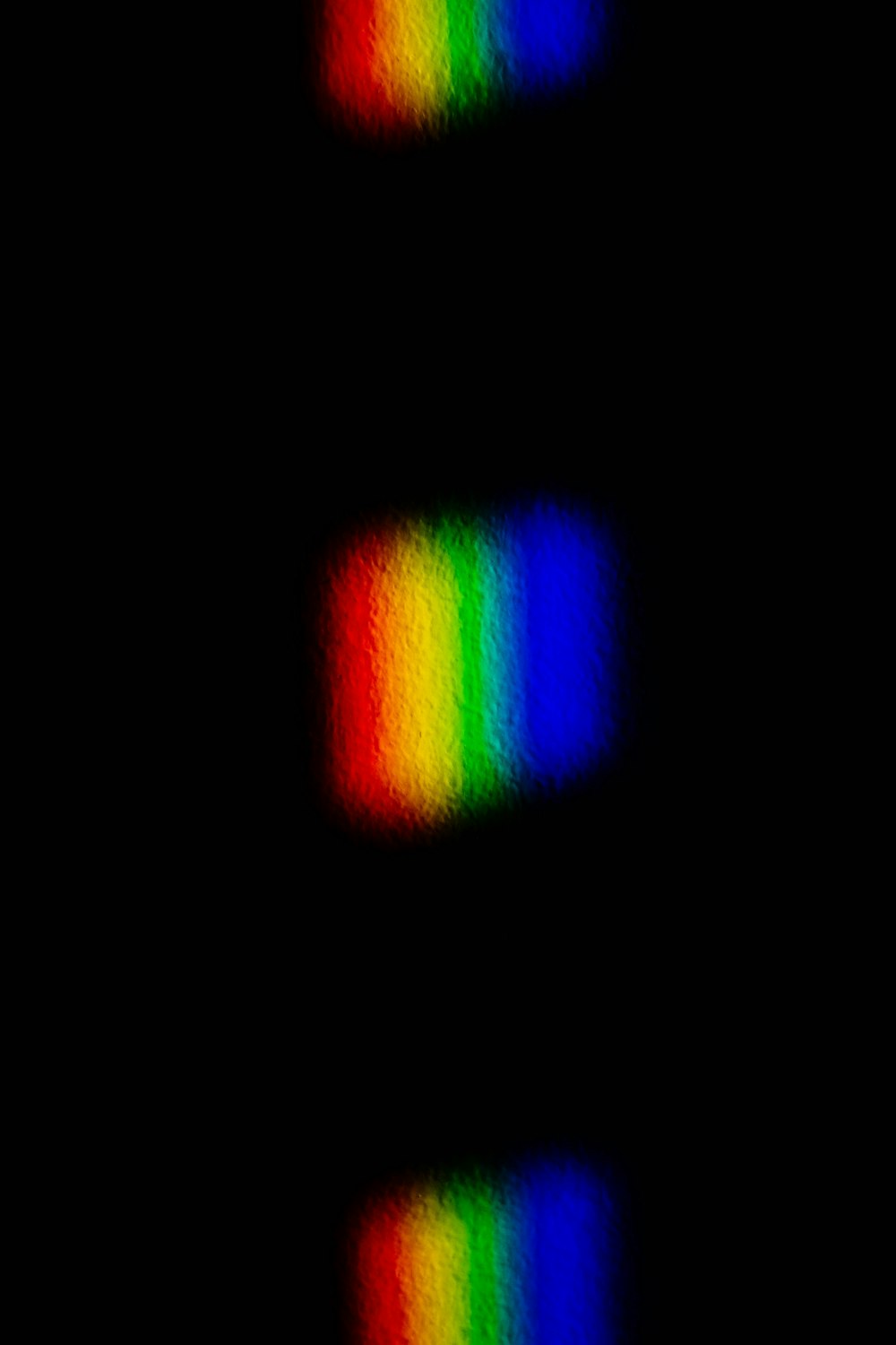 a black background with a rainbow pattern in the middle