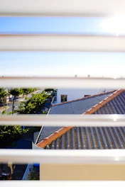 A friendly adjuster reviewing documents with a homeowner in a sunny South Florida neighborhood.