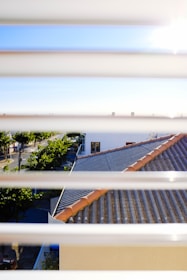 A freshly installed window screen glowing in the sunlight on a suburban home.