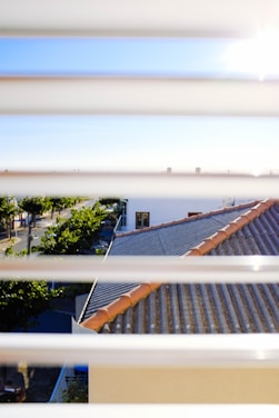 Chris conducting a thorough roof inspection on a sunny day in a suburban neighborhood.