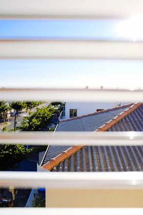 A friendly adjuster reviewing documents with a homeowner in a sunny South Florida neighborhood.