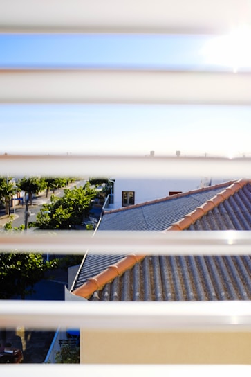 Chris conducting a thorough roof inspection on a sunny day in a suburban neighborhood.
