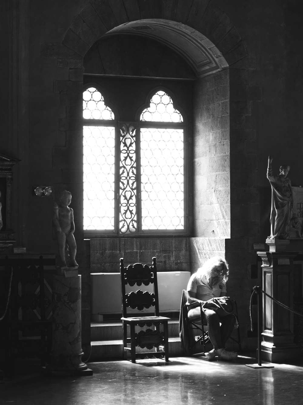 gray-scale photo of chair near window