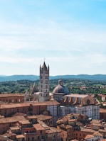 Historic Italian architecture with terracotta rooftops under a clear sky.
