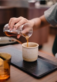 man holding Turkish tea glass
