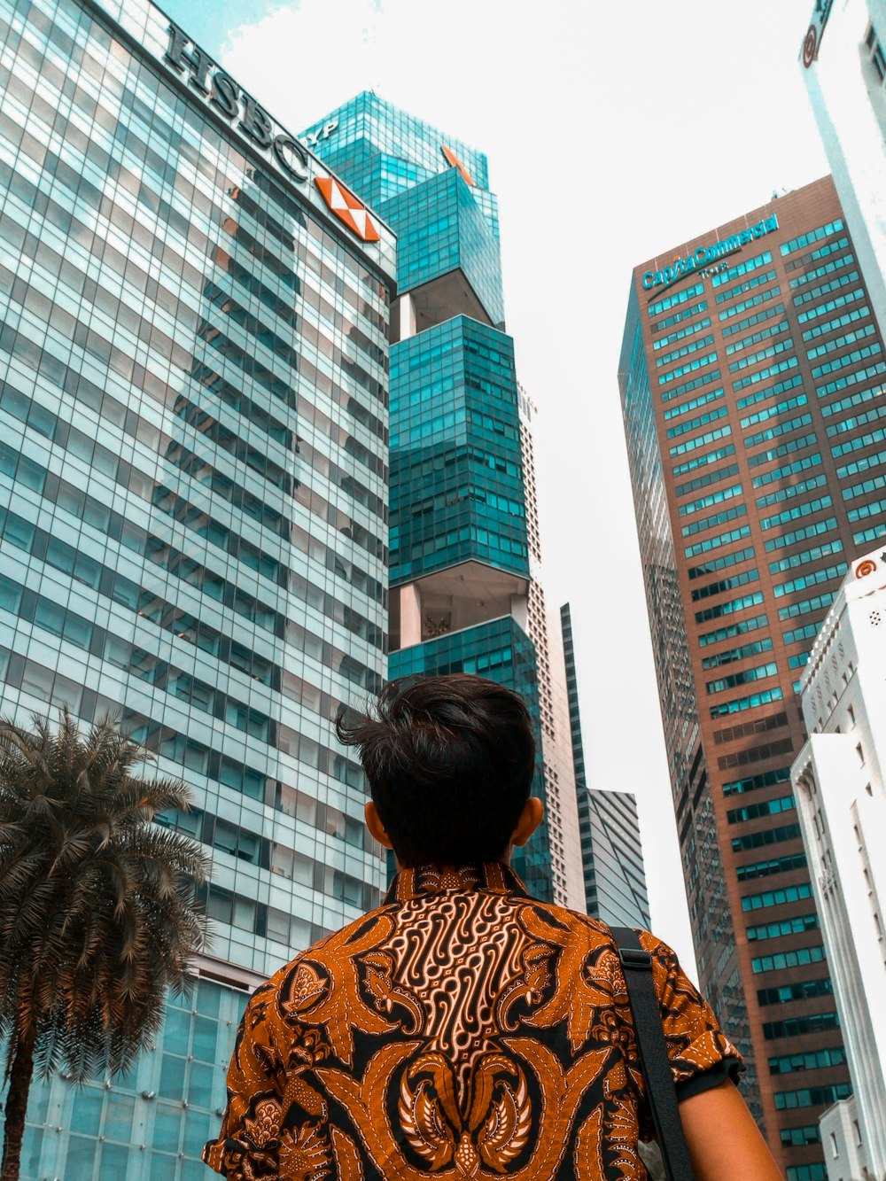 man standing front of curtain wall building