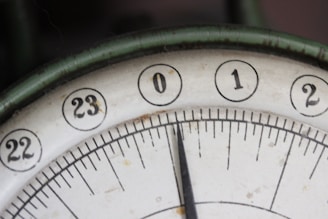 A close-up of a vintage clock with red hands, representing time and secrets.
