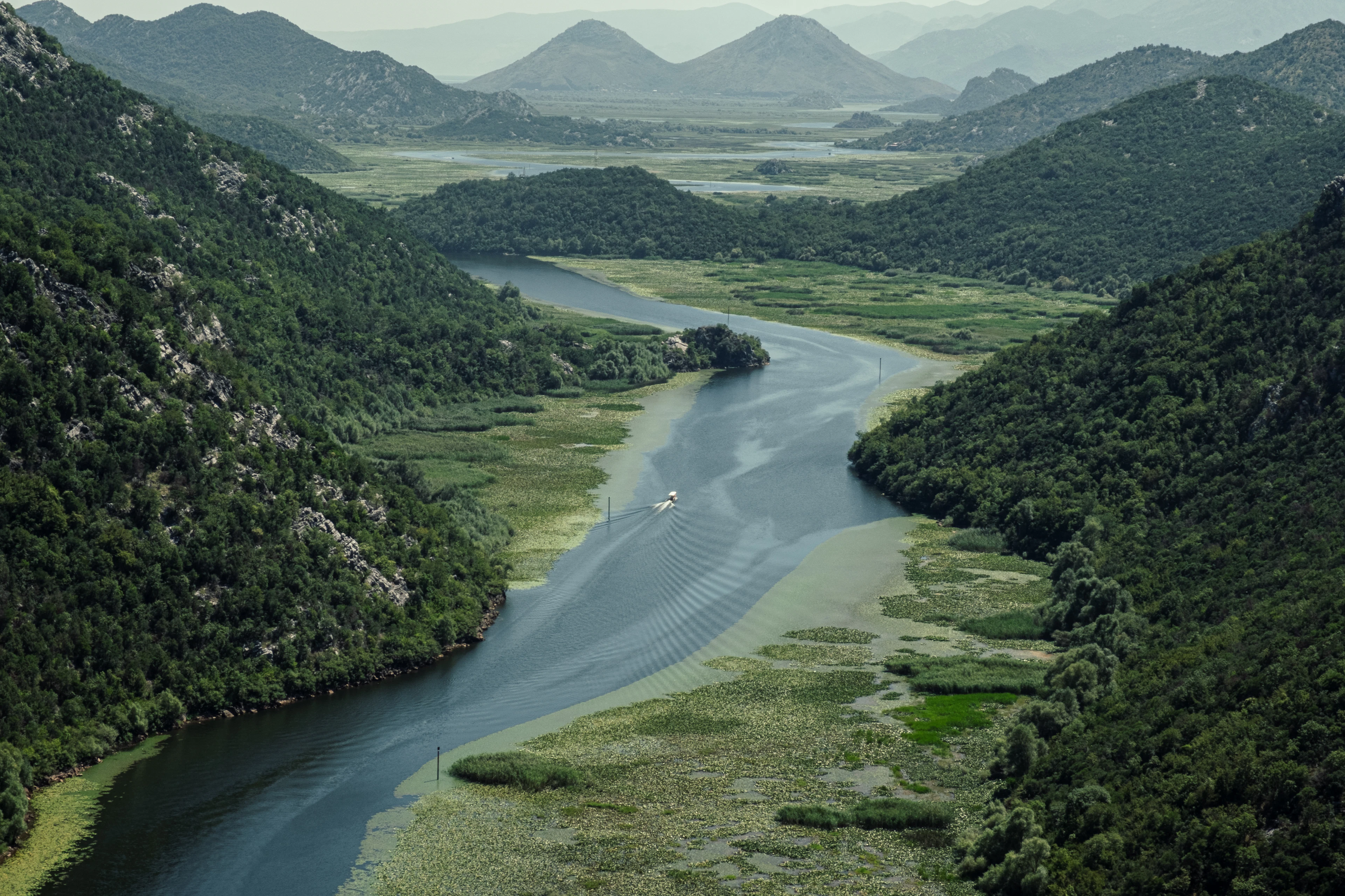 A river winding between green hills in the Lake Skadar area