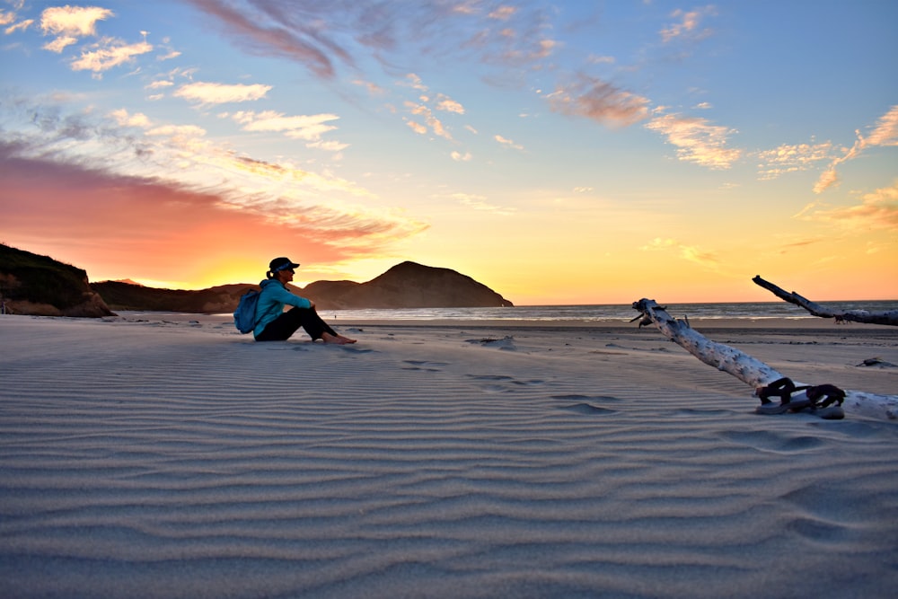 woman sitting on sand