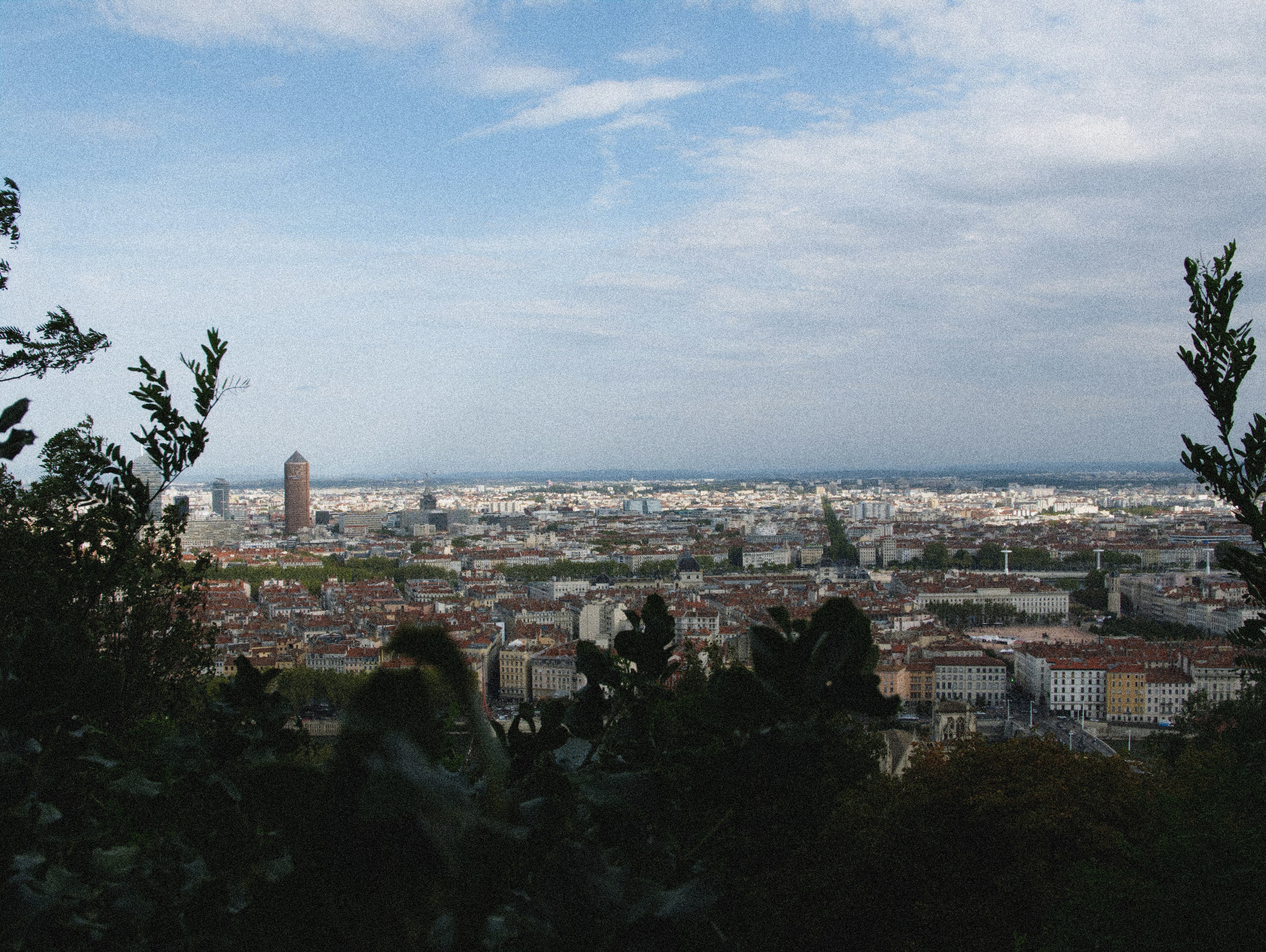 a view of a city from the top of a hill, 