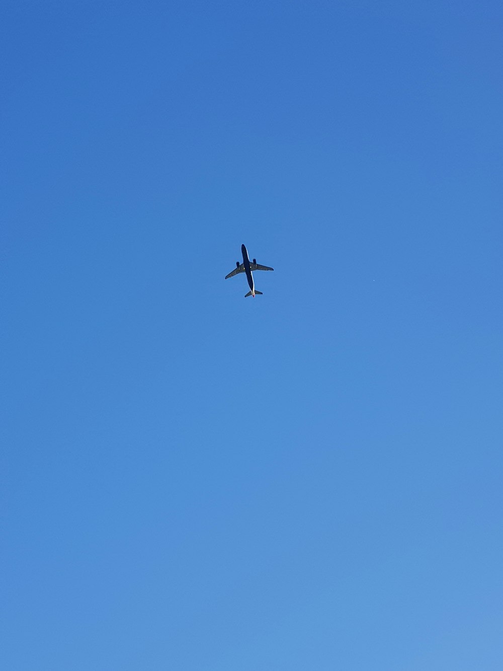 an airplane is flying high in the sky