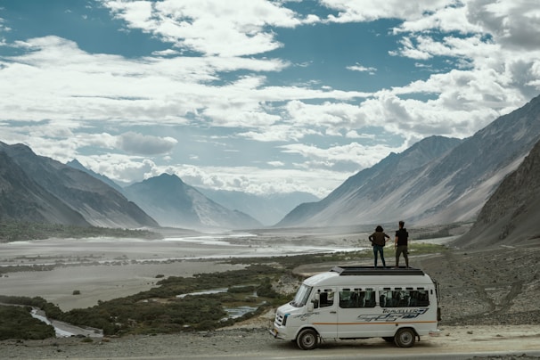 A happy couple enjoying a scenic mountain view during their Montenegro van tour.