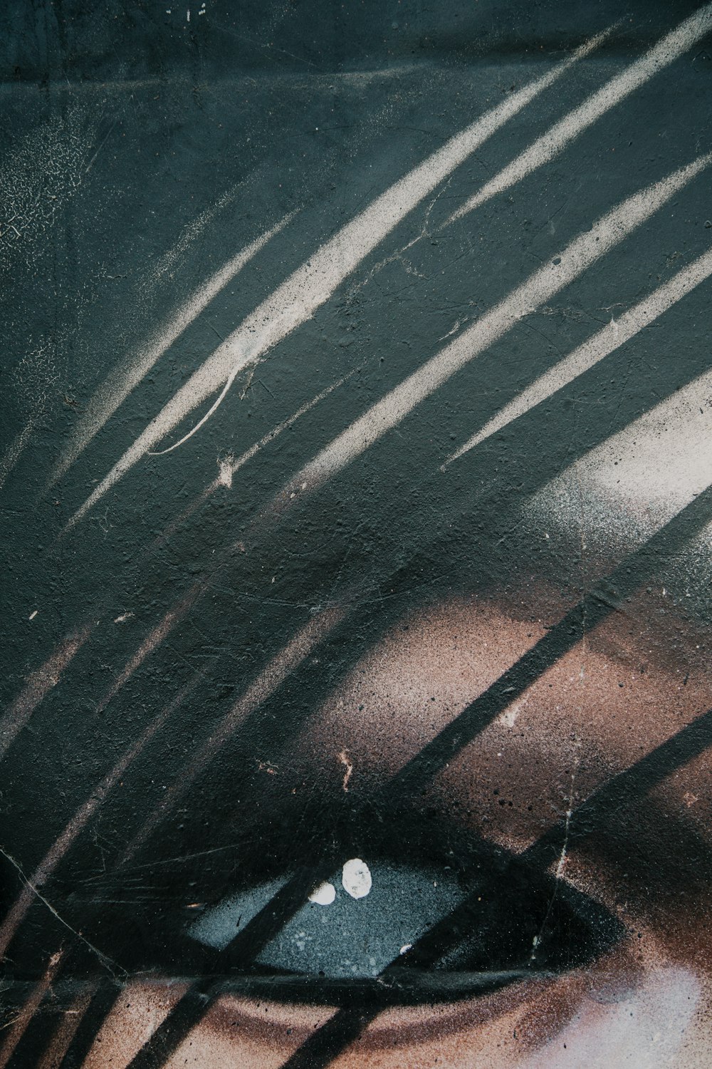 a close up of a person's eye with the shadows of bars on it