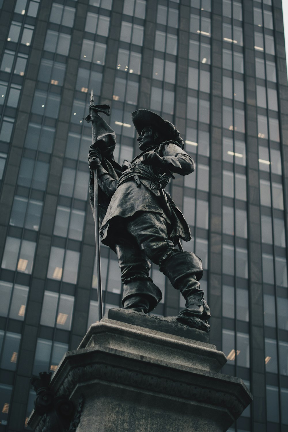 standing man holding spear statue