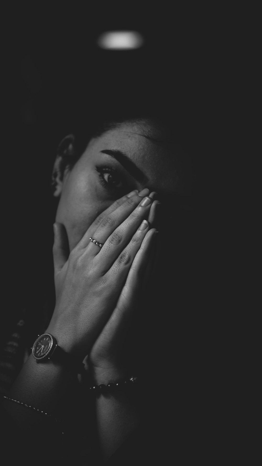 grayscale photography of woman covering her nose wit hands
