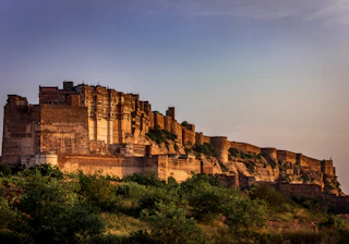 a very tall castle sitting on top of a hill