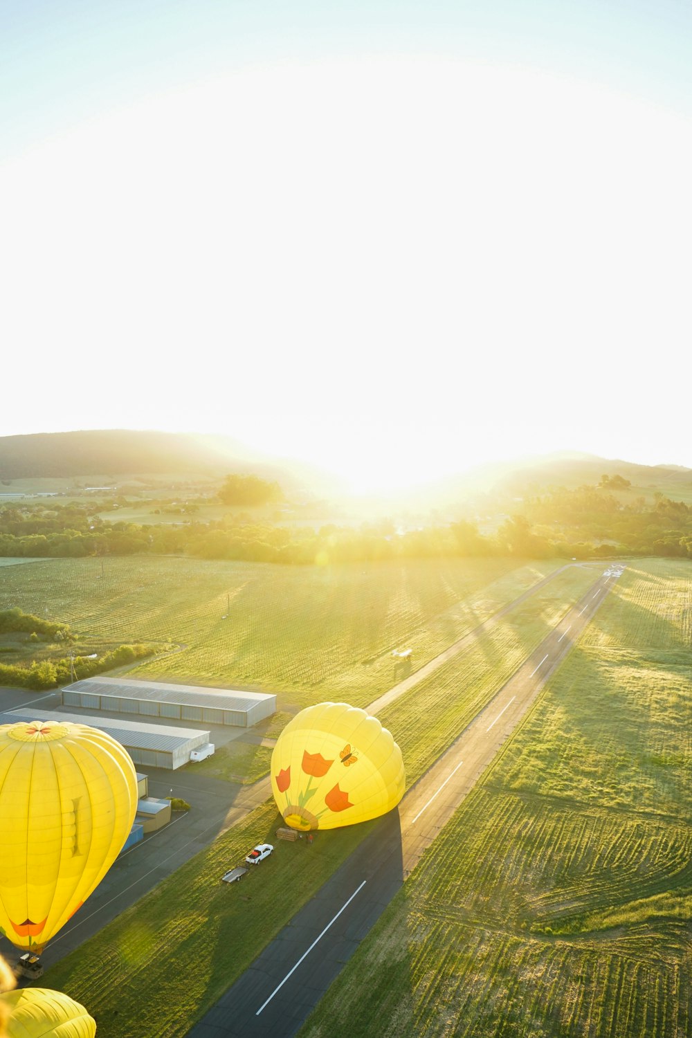 two hot air balloons on ground during daytime