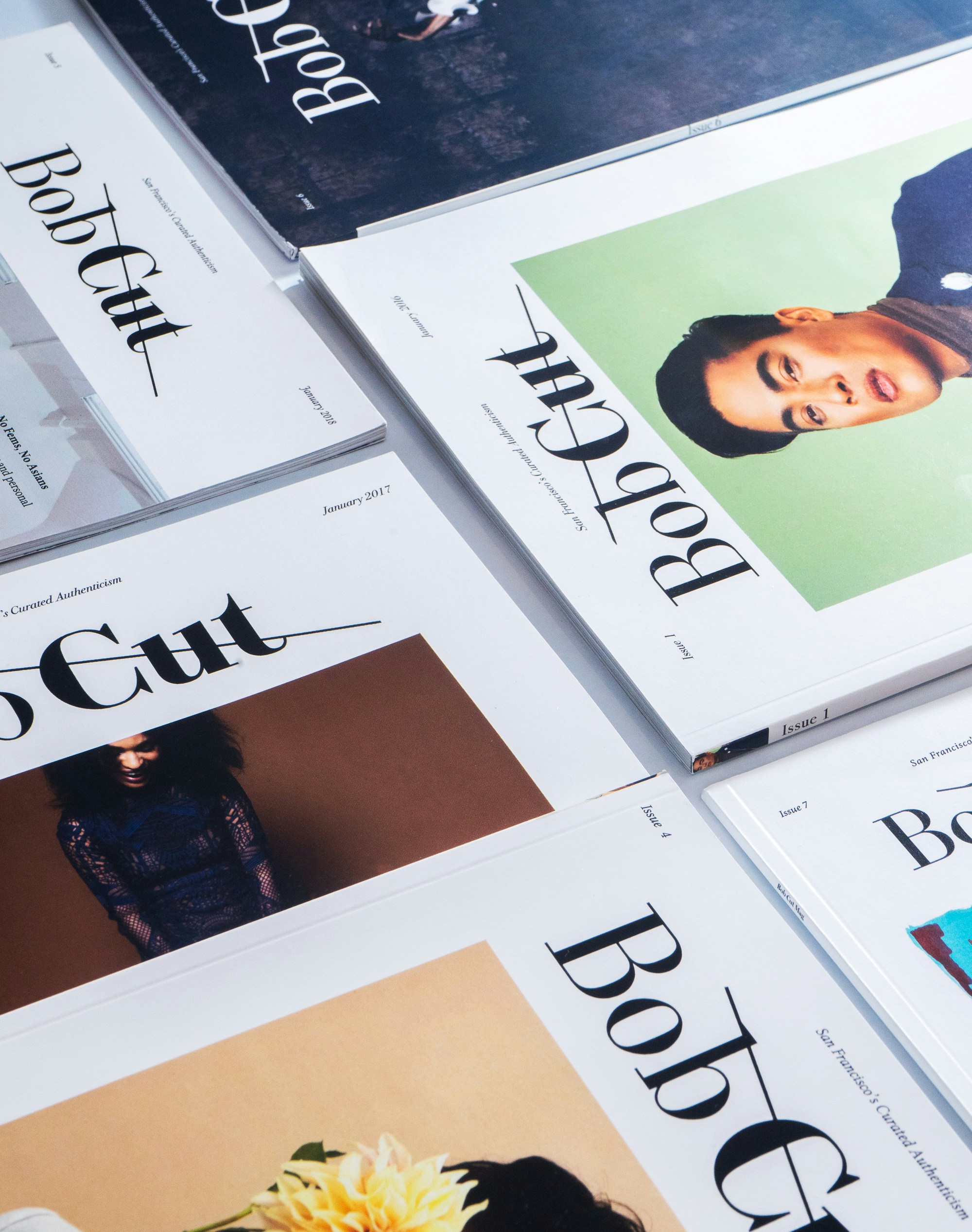 Magazines laying in a neat pile together.