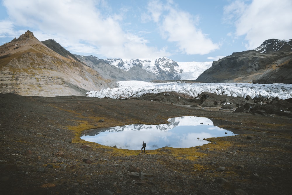 person walking near lake